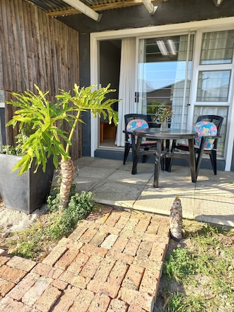 Outdoor dining. Triple Garden Suite