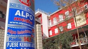 A hotel with a prominent sign advertising ALPO media and a bar-restroom. - Hotel Number One (Gjirokaster)