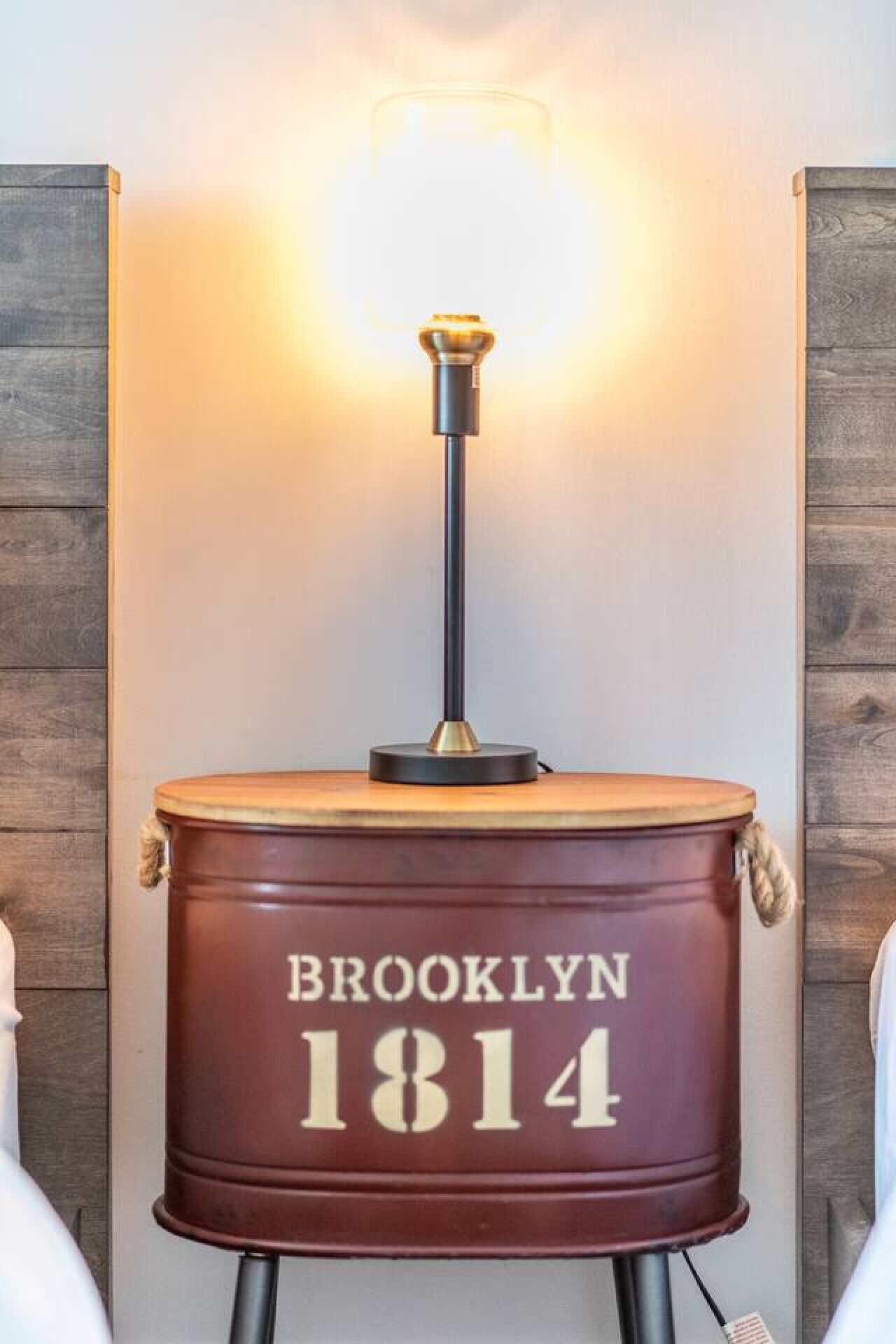 A drum-shaped lamp with the text "BROOKLYN 1814" on a wall.