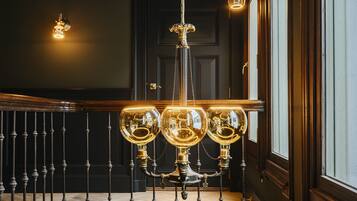 A chandelier with three glass globes and a central ornate fixture.