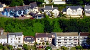 A coastal residential area with houses and a beach.