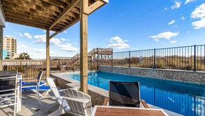 A pool area with a wooden deck, lounge chairs, and a view of the beach. - Spectacular Oceanfront HOME Large Media&Game Room 12 bed 12 bath OVERSIZED POOL (North Myrtle Beach)