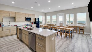 A modern kitchen with wooden cabinets, a central island, and built-in appliances. - Spectacular Oceanfront HOME Large Media&Game Room 12 bed 12 bath OVERSIZED POOL (North Myrtle Beach)