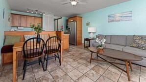 A compact living space with a kitchen, dining area, and seating area. - Beach theme, private Lanai, pools and tennis courts (Kihei)