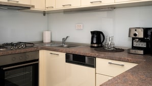 A modern kitchen with a gas stove, oven, dishwasher, and a coffee maker. - A2 - Modern apt With the Terrace & sea View (Split)