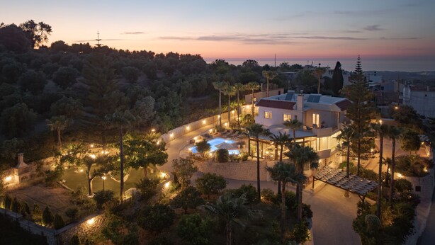 A residential area with a swimming pool, outdoor lighting, and a view of the surrounding landscape. - Kipo paradiso villa, pool,spa,massage,yoga,gym (Kyrianna)