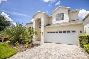 Experience the charm of this two-story property with a central garage and beautifully manicured grounds.
