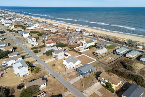 An aerial view of a coastal residential area with houses, roads, and a beach. - Oceanviews- Walk to beach in 2 mins. Pets welcome  (Kitty Hawk)