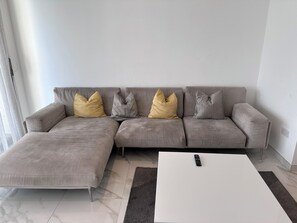 Relax in this stylish living space with a large L-shaped sofa and a coffee table.