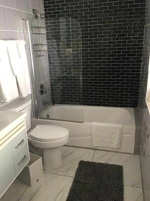 Combined shower/tub, hair dryer, towels, soap - A Suite Home entire pool home (Ocho Rios)