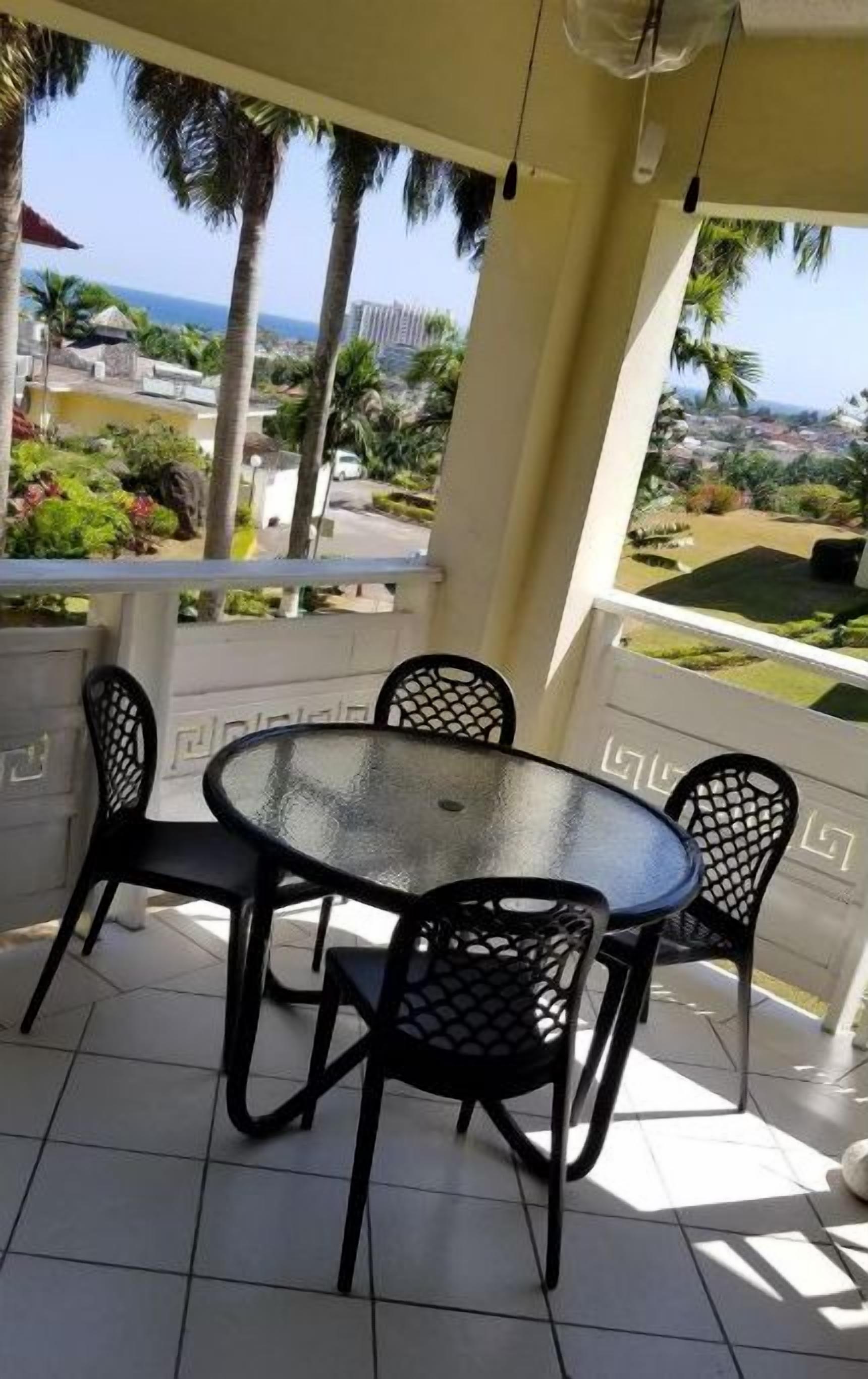 Veranda with nice ocean views . Outdoor ceiling fan for an extra breeze.