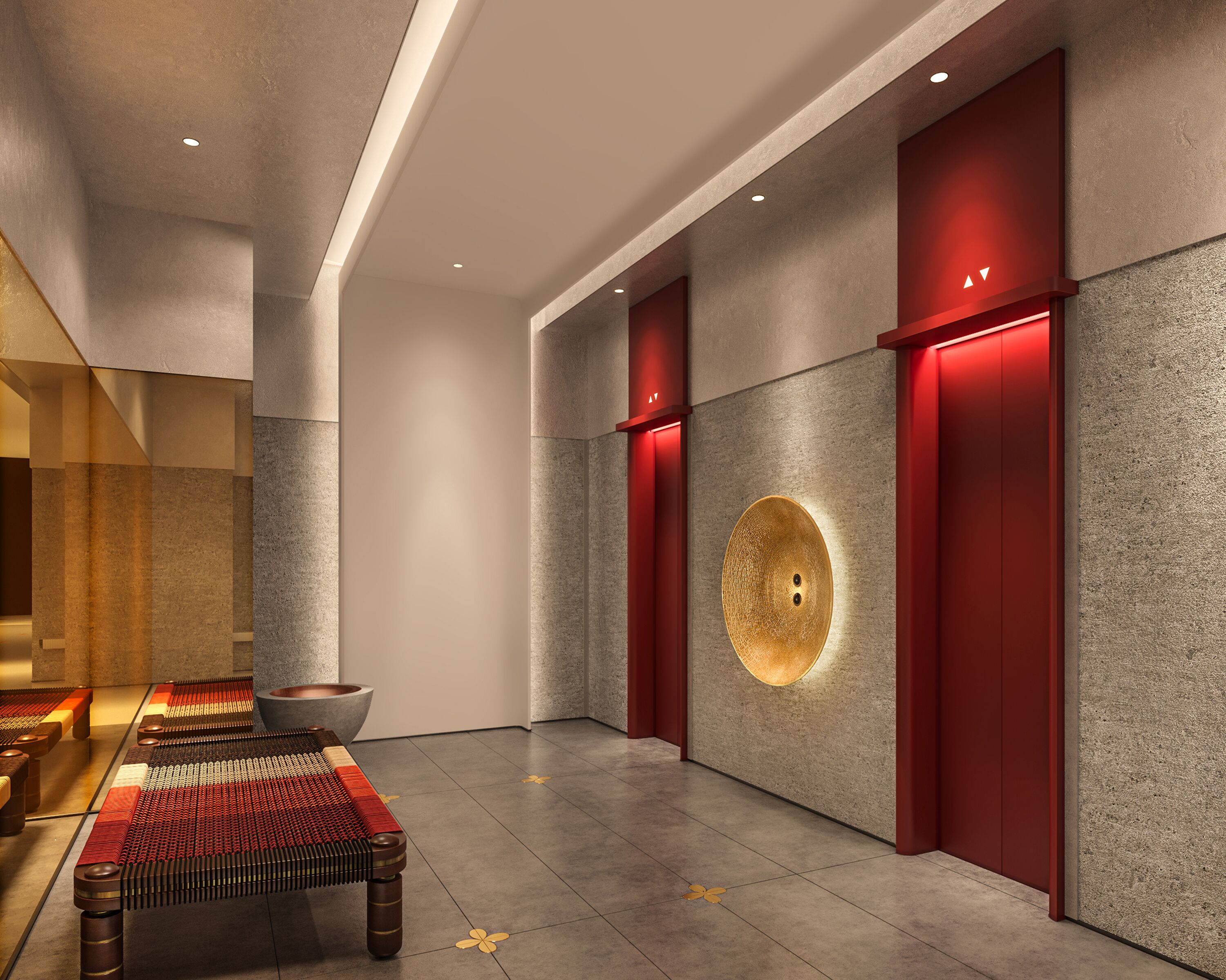 A modern interior with a central seating area, a textured wall with a circular light, and red accents.