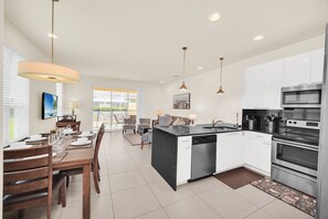 Enjoy meals in this well-equipped kitchen with a central island, sink, dishwasher, and oven.