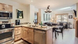 A modern kitchen with stainless steel appliances, a granite countertop, and a central island. - Upscale Luxury-Next to Slopes/Golf, View, Hottub (Copper Mountain)