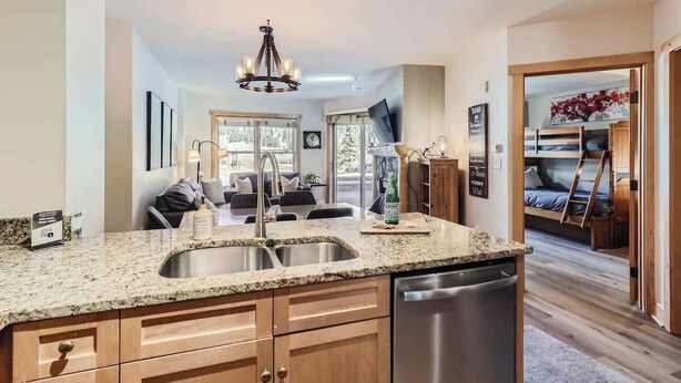 A modern kitchen with granite countertops, stainless steel appliances, and wooden cabinets. - Upscale Luxury-Next to Slopes/Golf, View, Hottub (Copper Mountain)