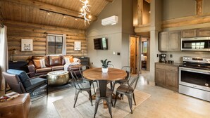 A spacious log cabin interior with a cozy living area, a dining table, and a modern kitchen. - Beautiful Log Cabin Near Fishing Access To Yellowstone (Livingston)