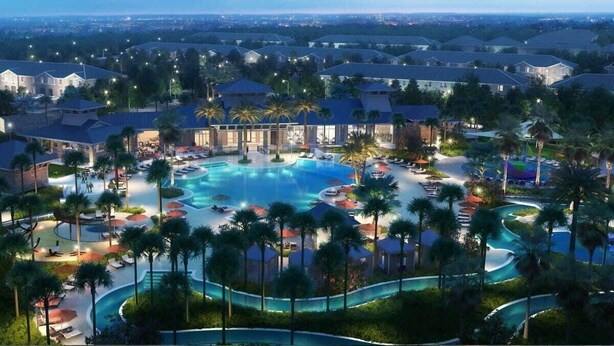 Een resort met een groot centraal zwembad, diverse gastenkamers en palmbomen.