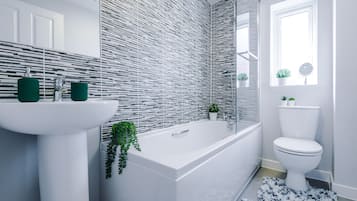 Combined shower/bathtub, hair dryer, towels, soap