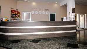 A reception desk with a clock displaying times for Berlin, Moscow, London, and Tokyo. - Villa Aurora (Varna)