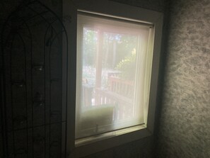 Enjoy a glimpse of the serene outdoor space from this simple, functional window.