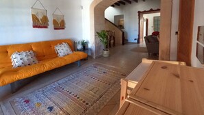 A living room with a sofa, a coffee table, a rug, and a wooden cabinet. - VILLA MARIA, NEAR PALMA BEACH (Sant Jordi, Palma)