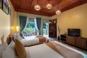 Un dormitorio con cama, televisor y vistas al exterior.