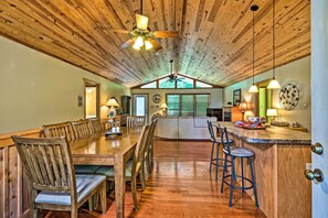 Enjoy meals in this dining area with a long table and comfortable seating for all.