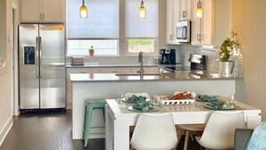 A modern kitchen with a central island, stainless steel appliances, pendant lighting, and a view to the outside. - Skyline Views/3 Miles to Downtown/WeeklyDiscounts/Pet Friendly (Nashville)