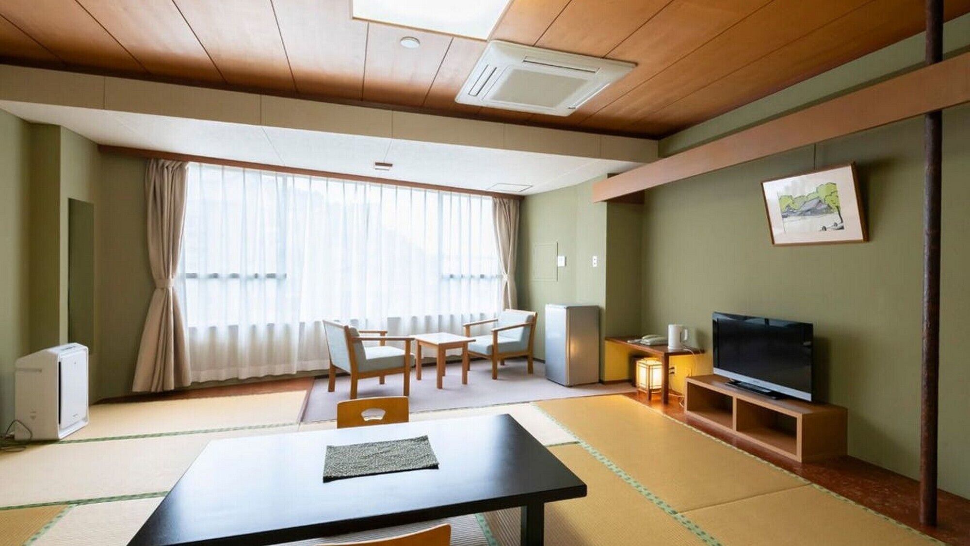 A room with a wooden ceiling, a dining table with chairs, a television on a stand, and a painting on the wall.