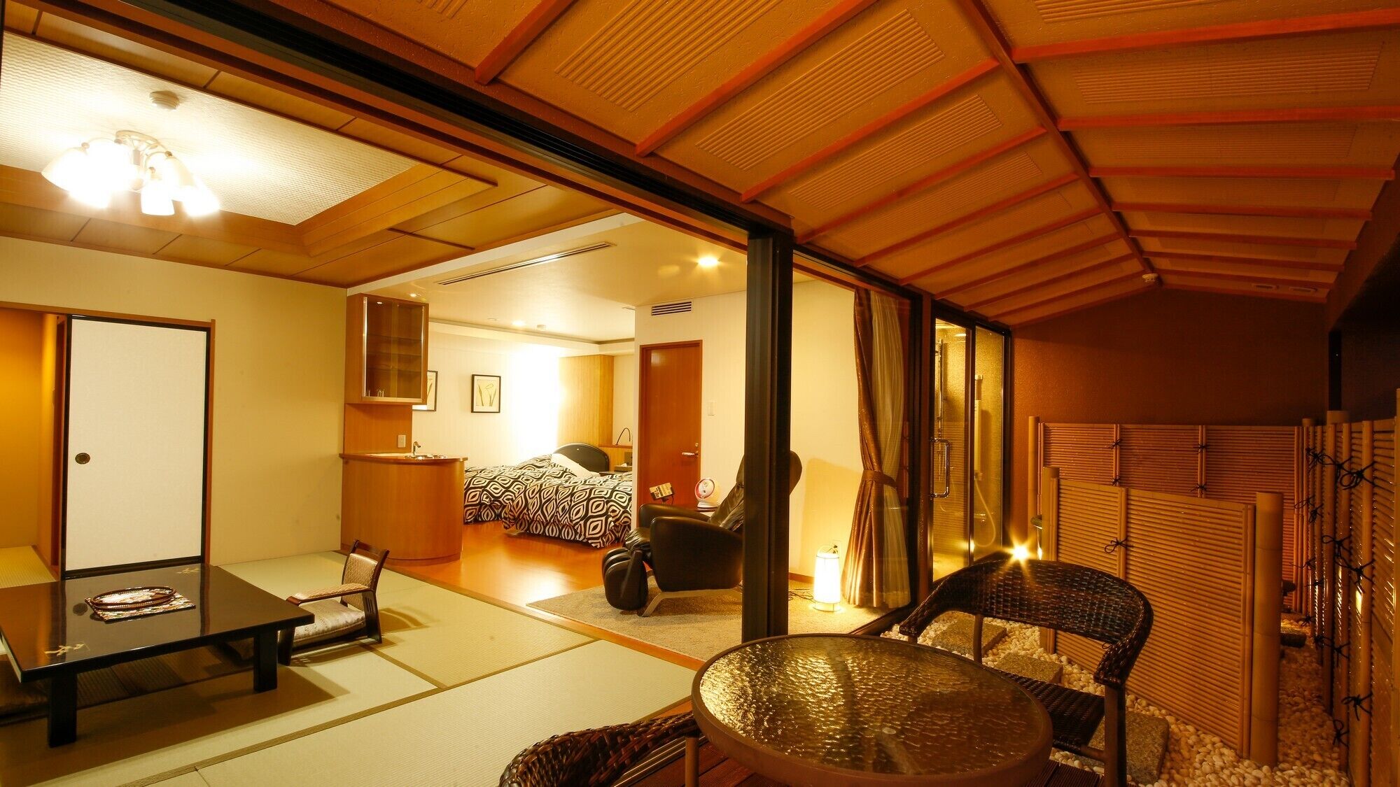 A traditional Japanese-style room with tatami flooring, a low table, a chair, and a sliding door leading to another room.