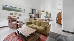 A modern living room with a sofa, a recliner, and a coffee table. - Modern on Main-Walking Distance to Downtown Hill City and Mickelson Trail! (Hill City)