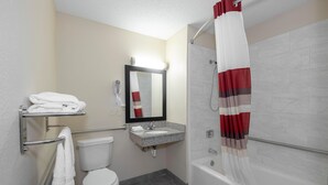 A bathroom with a toilet, sink, and bathtub. - Red Roof Inn Bristol (Bristol)