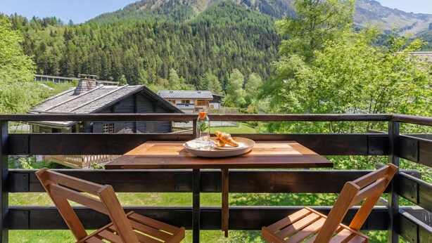 A wooden deck with a table and chairs, overlooking a mountainous landscape. - Résidence le Chardonnet G 1BR for 4 w/Shared Pool & panoramic views, Argentière (Chamonix), France (Argentière (Chamonix))