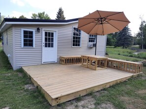 Outdoor dining - Cozy cabin retreat in rustic setting. Private lake, bonfire under the stars! (Lake)