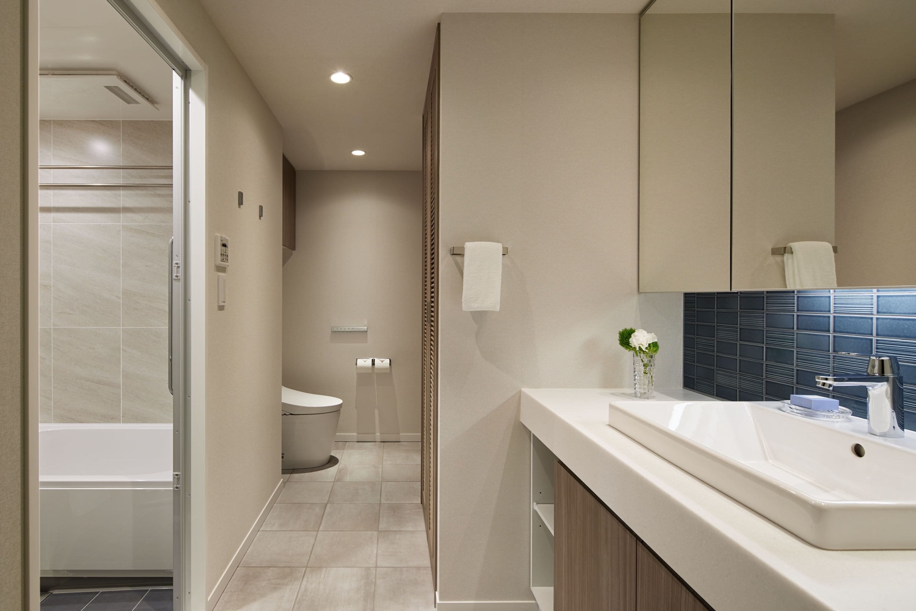 A modern bathroom with a bathtub, toilet, and sink.
