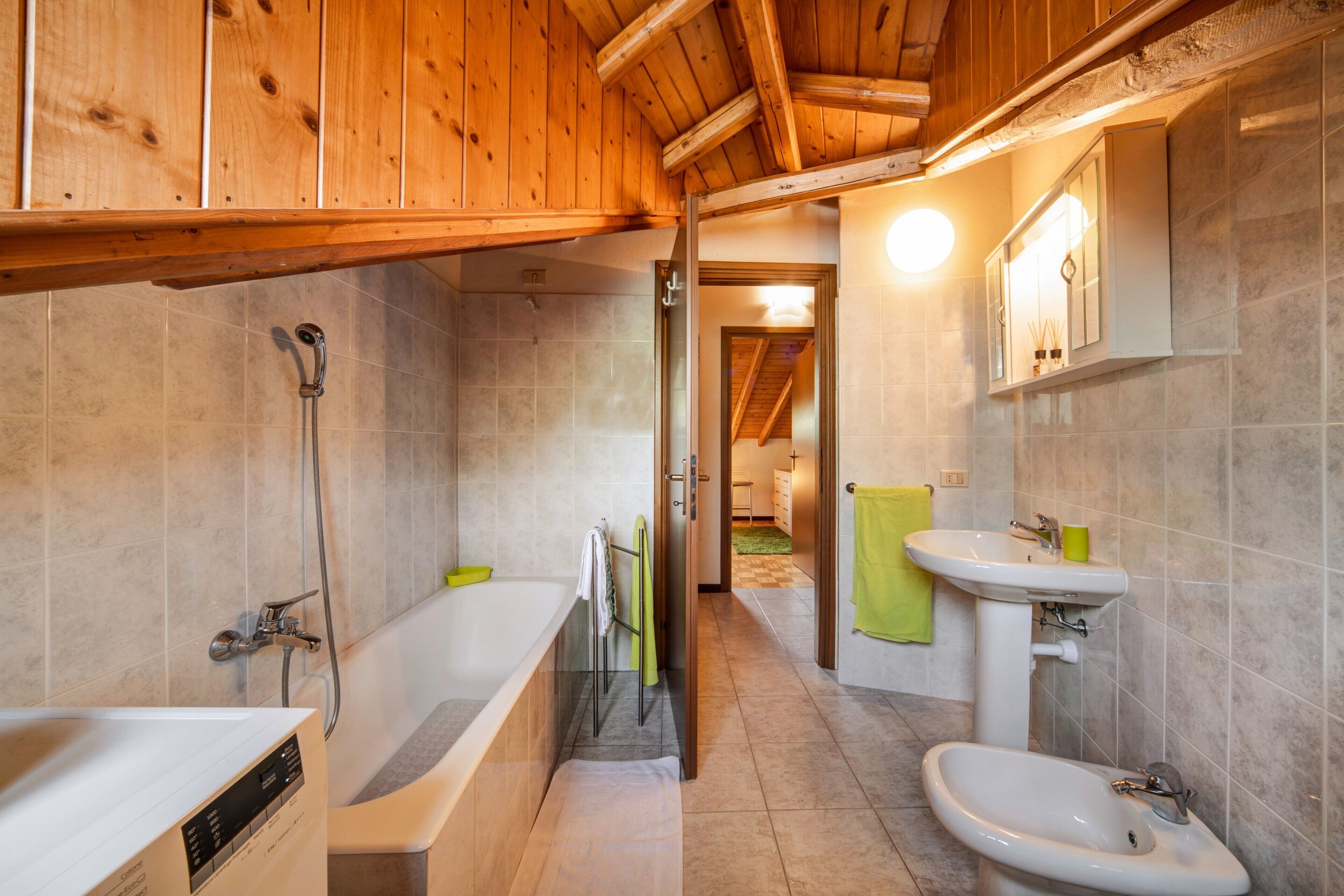 A modern bathroom with a bathtub, sink, and shower.