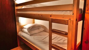 A bunk bed with wooden frames and white bedding. - Bright Savoyard studio with south-facing balcony (Le Grand-Bornand)
