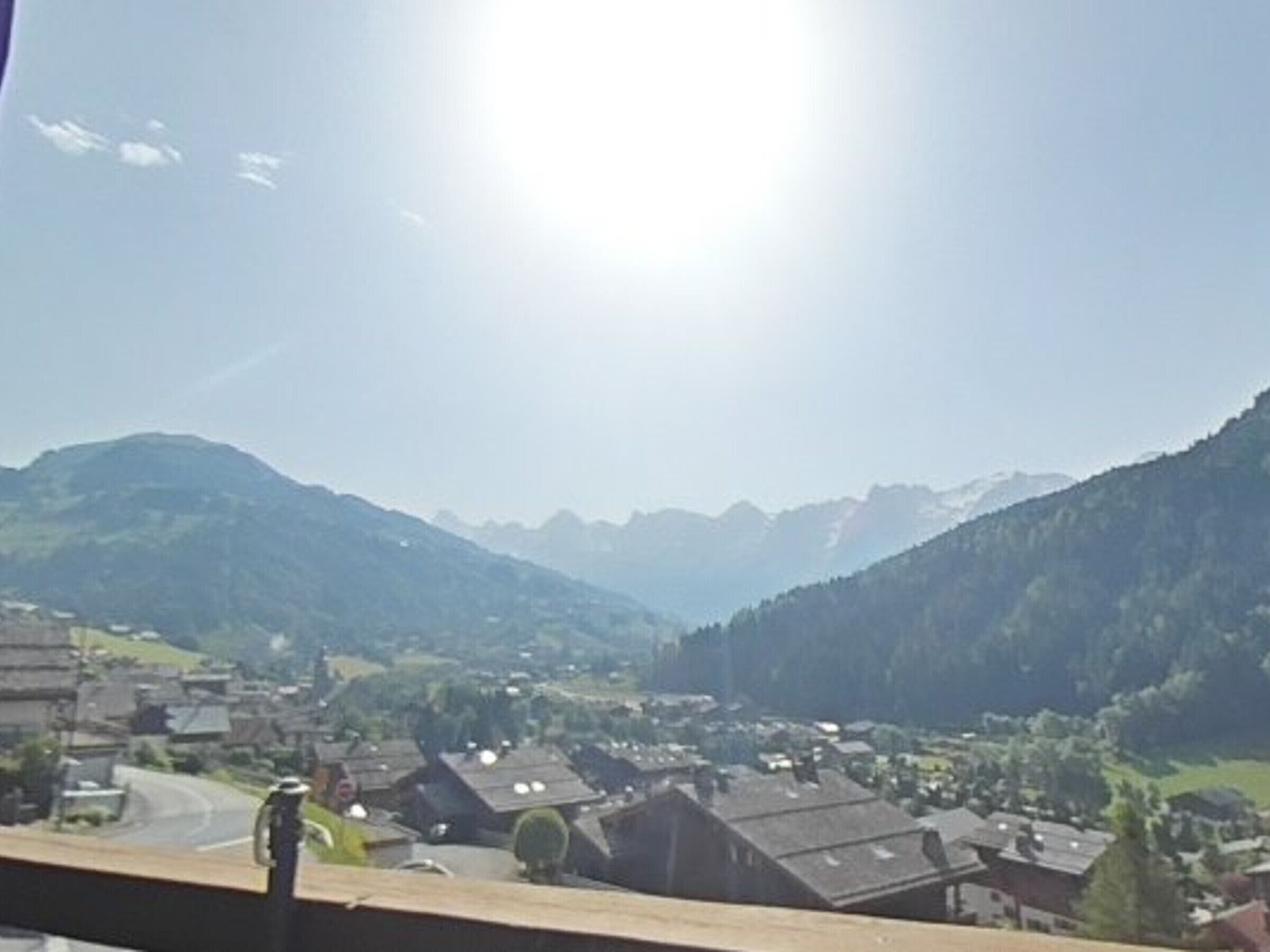 A mountain village with houses and a road.