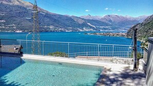 A swimming pool with a view of a lake and mountains. - FOREVER by Design Studio (Bellano)