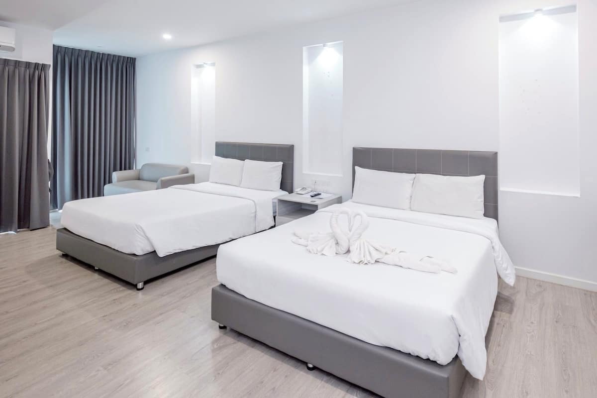 A modern hotel room with two beds, a sofa, a nightstand, and a large window with curtains.