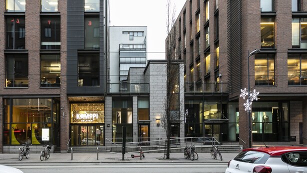 A modern building with a glass storefront and a visible sign for 'KARPPI HELSINKI'. - 2ndhomes Kamppi Center Apartment 9 (Helsinki)
