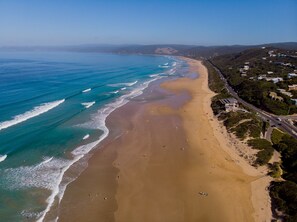 A coastal beach with a road adjacent to it. - Cowallinga (Fairhaven)