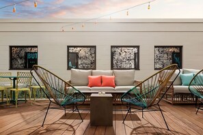 A modern lounge area with a sofa, two armchairs, a coffee table, and a patterned wall. - Boston Getaway! 3 Spacious Units (Boston)