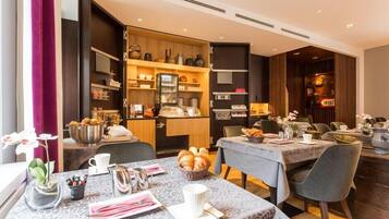 Enjoy dining in style with a beautifully set table and a buffet area offering a variety of options.