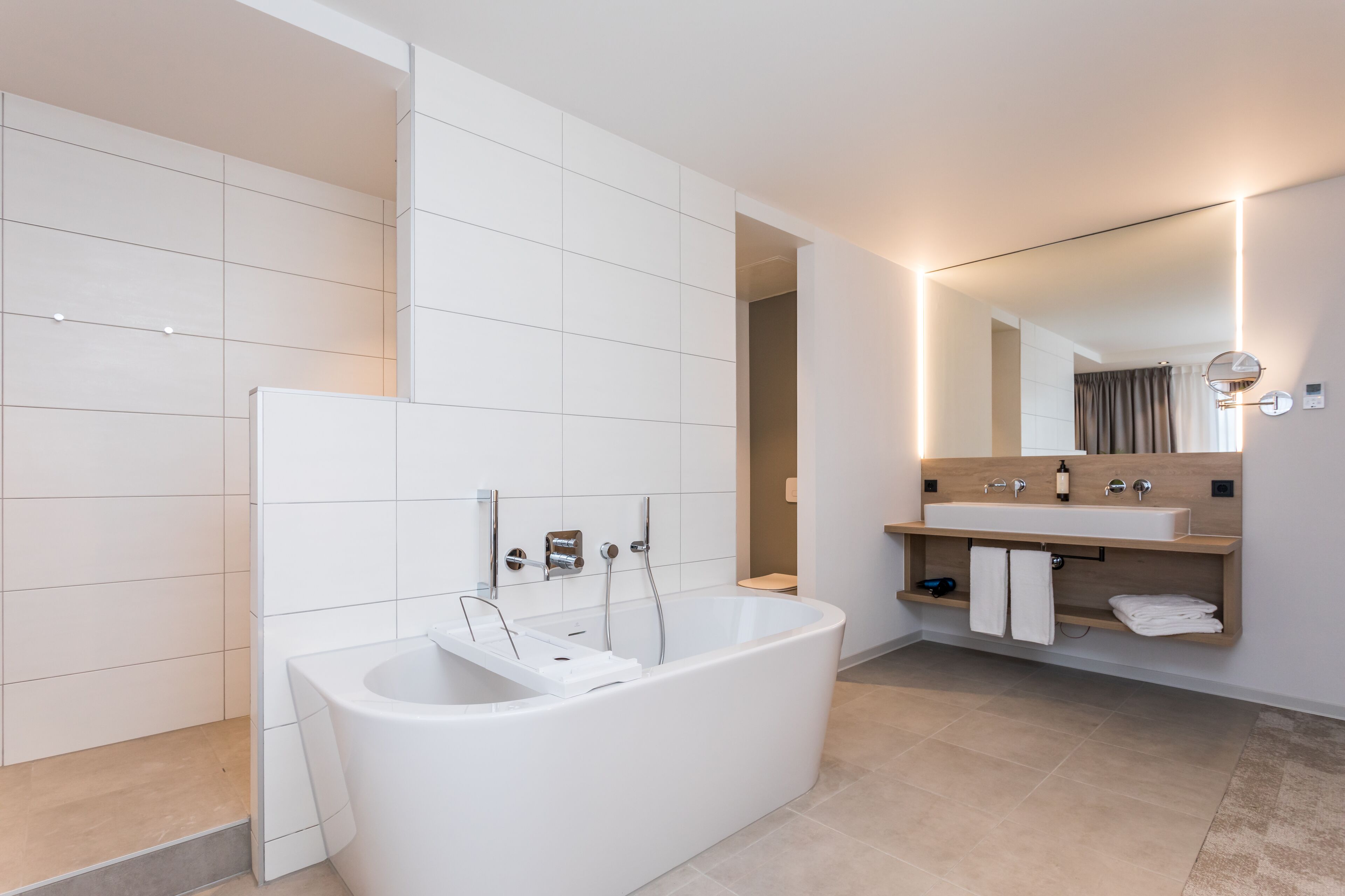 comfort suite, bathtub (deluxe) | bathroom | hair dryer, slippers, towels