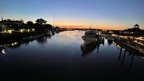 A marina at dusk with boats docked, calm water, and buildings on either side. - Renovated & Spacious Retreat on East Rt 1 – Pool, Bike Trails, Mins to Beach! (Lewes)