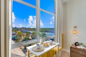Enjoy a cityscape view from the comfort of your room, featuring a dining area and a cozy reading nook.