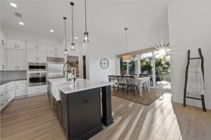 Enjoy meals in the spacious kitchen with a central island and large window offering a view of the outdoors.