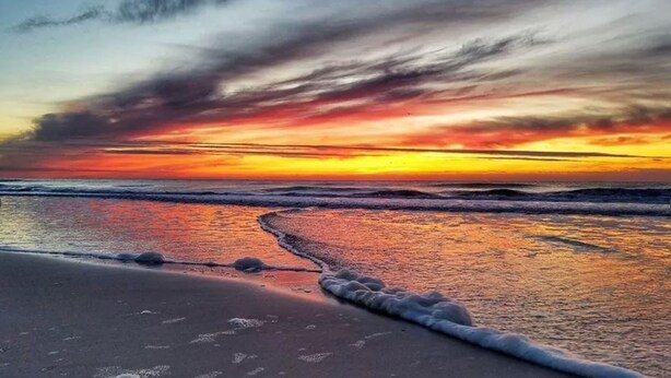 A beach with waves at sunset. - Waterfront: Dock Access, Walk to Beach, Pier & Shops, 5BR, Sunset view / 10% off (Surf City)