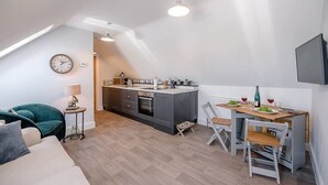 A modern loft apartment with a kitchen, dining area, and a cozy seating area. - Geoff's Rest with Hot Tub, Pond Hall Farm, Hadleig (Ipswich)